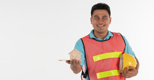 Portrait of a smiling young man against white background