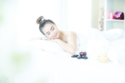 Portrait of woman lying on table