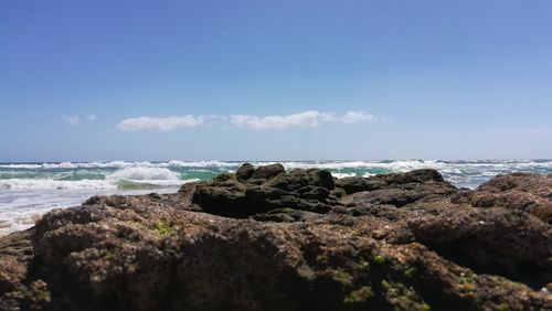 Rocks on beach against sky