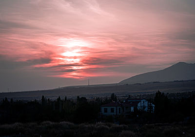 Scenic view of landscape against romantic sky at sunset