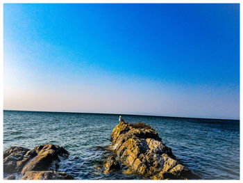 Scenic view of sea against clear blue sky