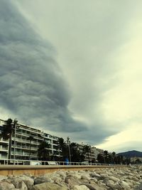 Low angle view of building against cloudy sky