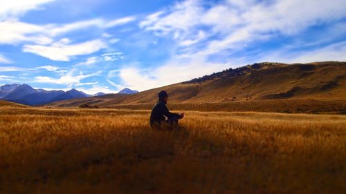 Man on field against sky