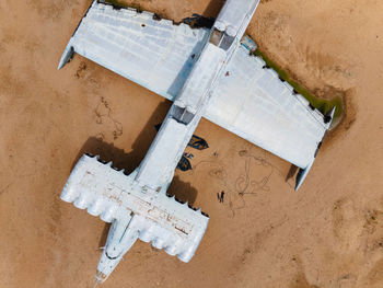 Military abandoned lun plane stands on a beach in dagestan