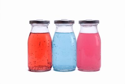 Close-up of multi colored glass against white background