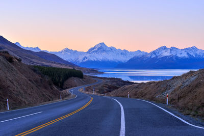 Scenic view of mountain road against sky during sunset