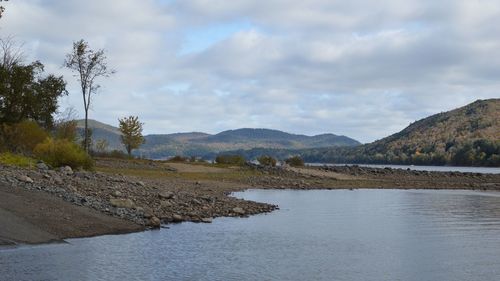 Scenic view of lake and mountains against sky