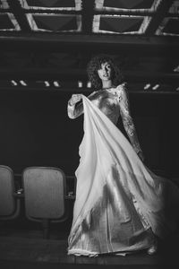 Young woman in dress standing on stage