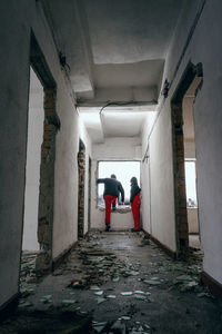 Rear view of people in abandoned building