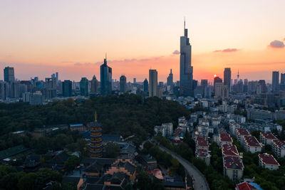 Aerial view of buildings in city during sunset