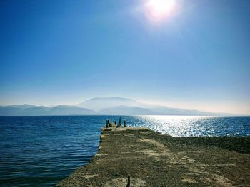 Scenic view of sea against sky on sunny day