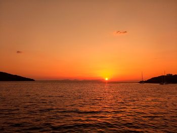 Scenic view of sea against orange sky