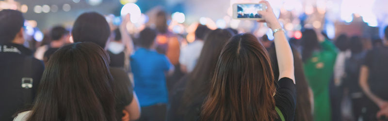 Rear view of people enjoying music concert