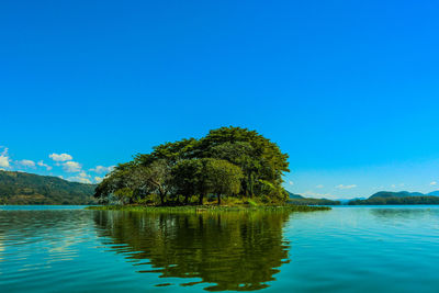 Scenic view of lake against blue sky