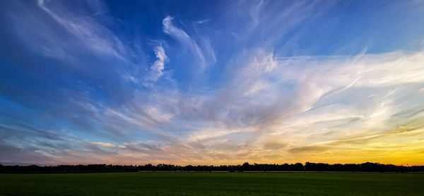 Scenic view of field against sky during sunset