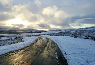 Scenic view of snow covered landscape against sky