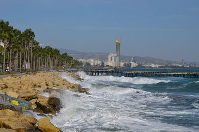 Scenic view of sea and buildings against sky