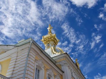 Low angle view of gold church against blue sky