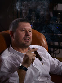 Close-up of man smoking cigar