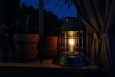 Close-up of illuminated lantern on table