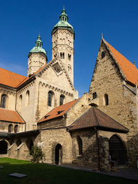 Low angle view of historic church building against clear blue sky