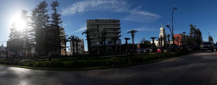 Panoramic view of city street and buildings against sky