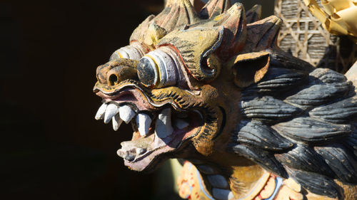 Close-up of animal statue against black background