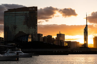 View of modern buildings against sky during sunset