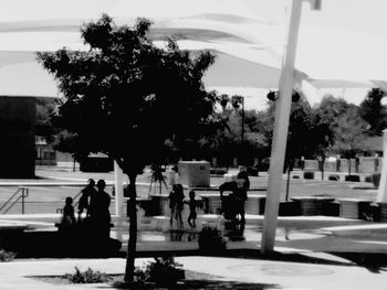 Rear view of people walking on sidewalk