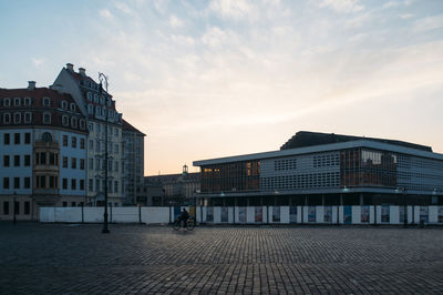 Buildings in city against cloudy sky