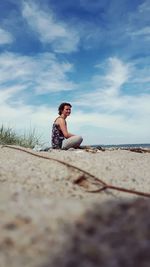 Young woman sitting at beach