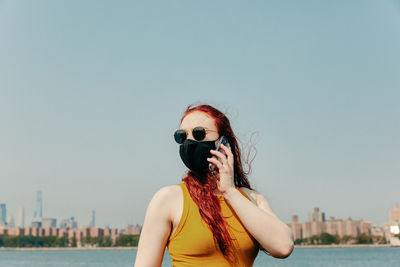 Portrait of man wearing sunglasses against clear sky