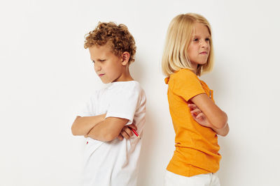 Sibling standing against white background against white background