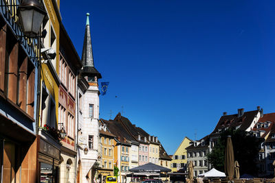 Low angle view of houses against blue sky