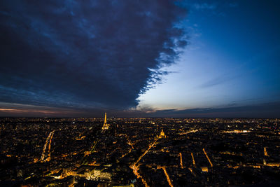 High angle view of illuminated city against sky at night