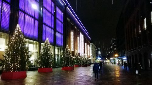 Reflection of illuminated buildings in city at night