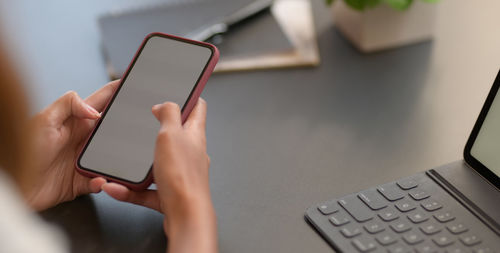 Midsection of woman using mobile phone