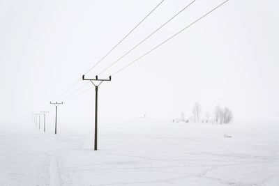 Scenic view of snow covered land against sky