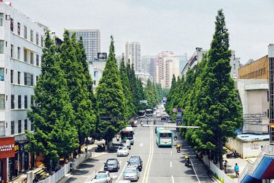 Cars on road in city against sky