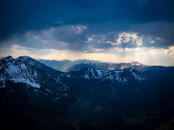 Scenic view of snowcapped mountains against dramatic sky