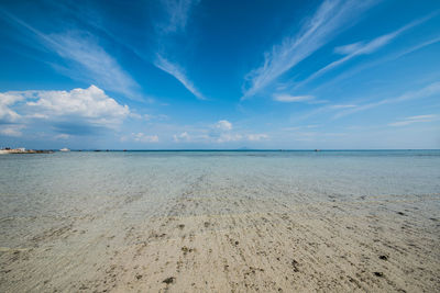 Scenic view of beach against blue sky