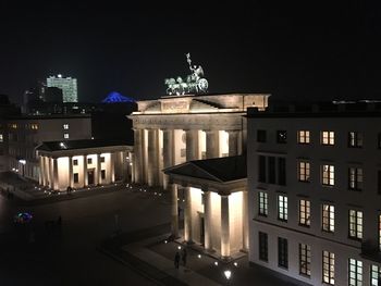 Statue in city at night