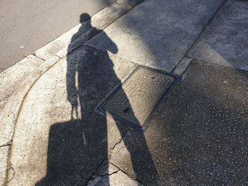 Shadow of person on street in city