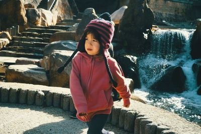 Full length of cute girl standing in water