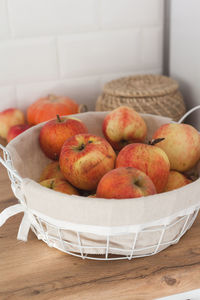 Close-up of apples in basket on table