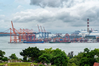 Commercial dock by sea against sky