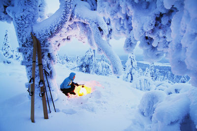 Woman having campfire at winter