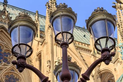 Low angle view of street light against building