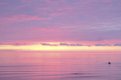 Scenic view of sea against romantic sky at sunset