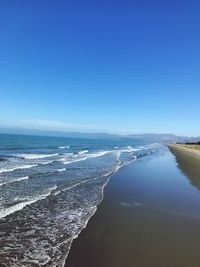 Scenic view of sea against clear blue sky